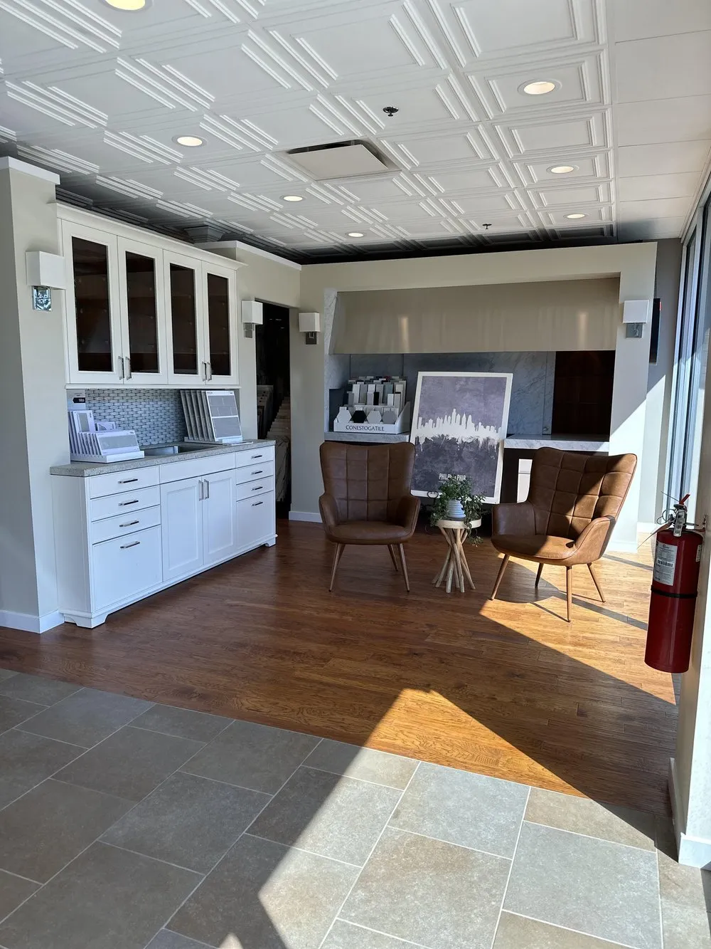 Seating area in the Cherry Hill showroom, with hardwood, tile, and white cabinetry.