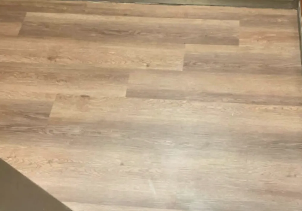 Light oak-look luxury vinyl planks installed in an apartment.